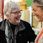 female-carer-and-client-laughing-market